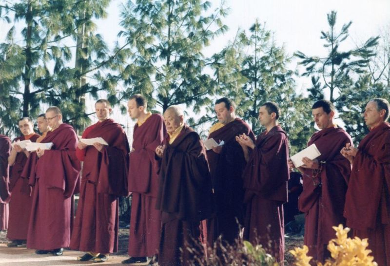 At the end of the first traditional retreat at Dhagpo Kundreul Ling, the first group of men to have completed it pray in front of the stupa with Gendun Rinpoche, on June 11, 1987