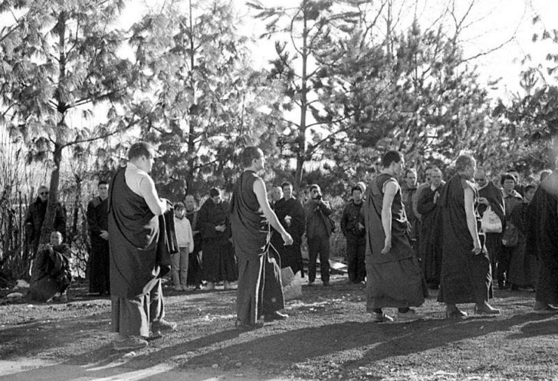 At the end of the first traditional retreat at Dhagpo Kundreul Ling, the first group of men to have completed it pray in front of the stupa with Gendun Rinpoche, on June 11, 1987