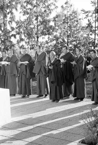 At the end of the first traditional retreat at Dhagpo Kundreul Ling, the first group of men to have completed it pray in front of the stupa with Gendun Rinpoche, on June 11, 1987